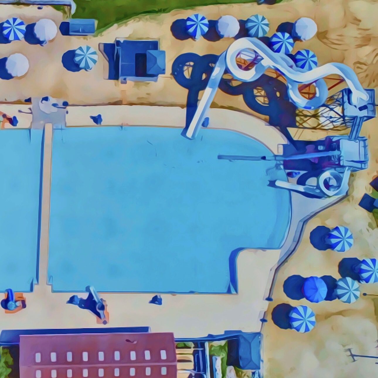 A top-down view of a swimming pool with surrounding lounge chairs and umbrellas.
